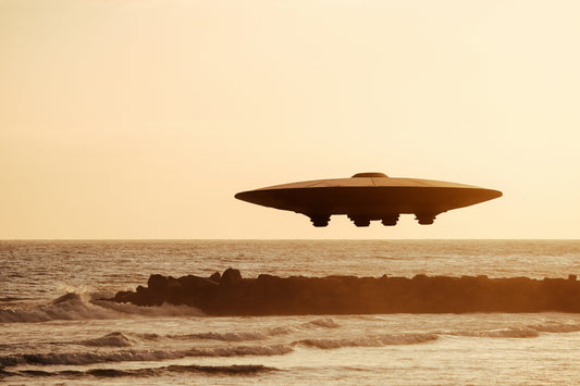 A UFO over the ocean and some rocks